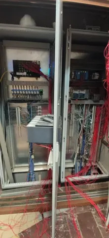 Closer view of the control-cabinet wiring and installed modules.